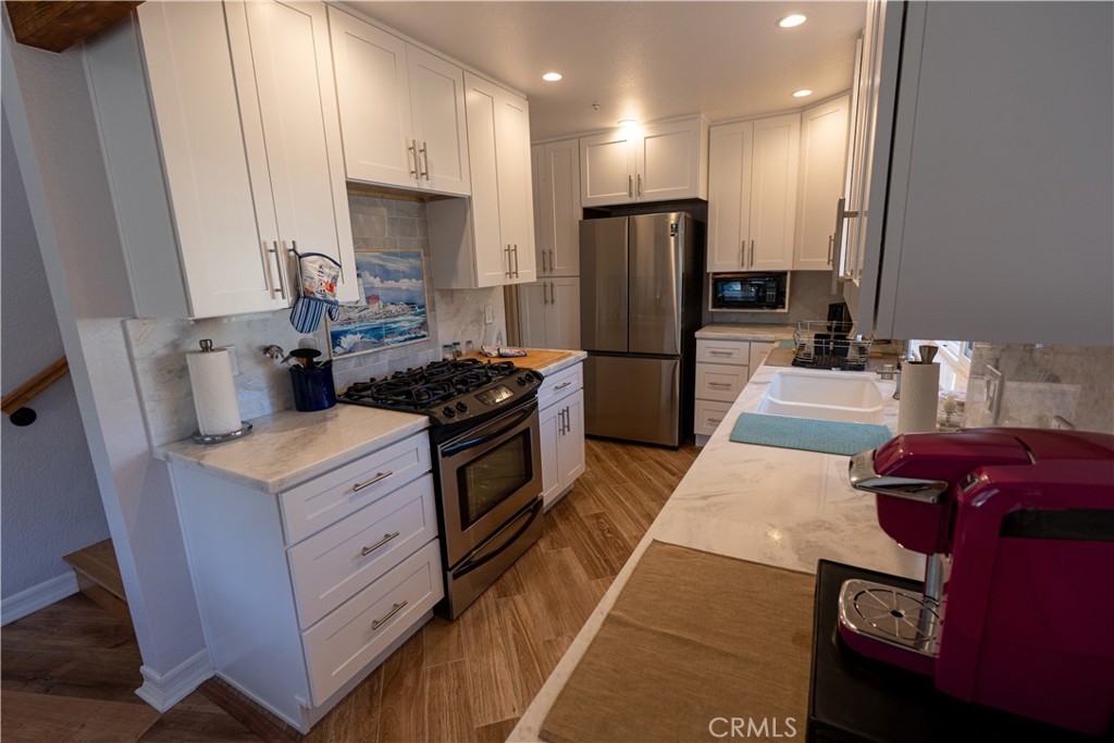 258 West Escalones, Unit 6R San Clemente, CA 92672 - Photo 10 of 22 a kitchen with furniture a refrigerator and a stove