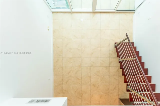 a view of hallway with a door and a window