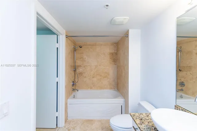 a bathroom with a tub and shower