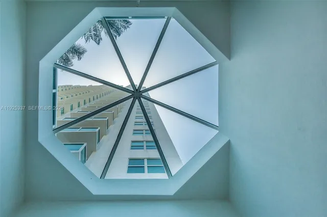 a living room with furniture and large windows