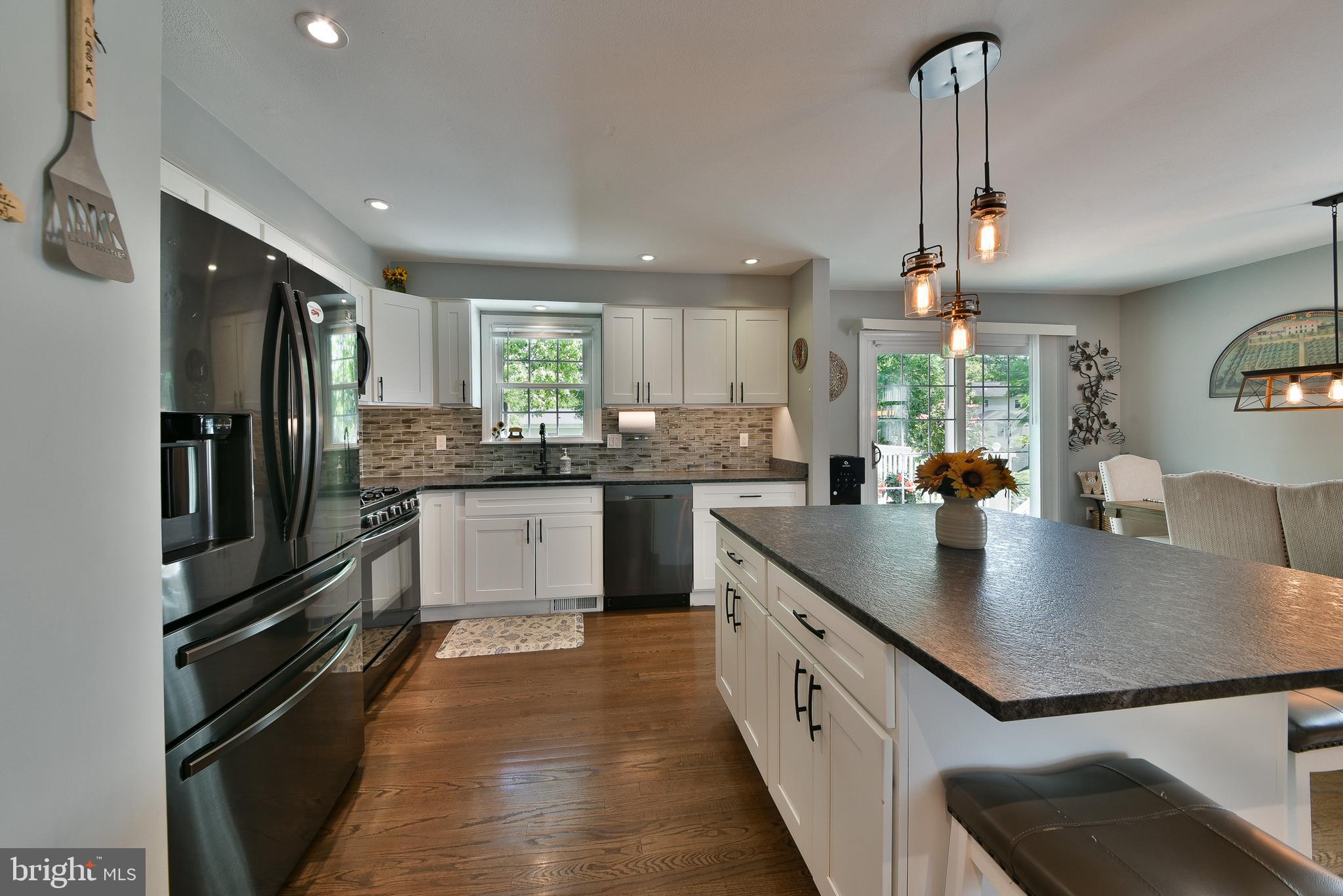 192 Bull Run Road Ewing, NJ 08638 - Photo 11 of 46 a kitchen with stainless steel appliances granite countertop a sink a stove and a refrigerator