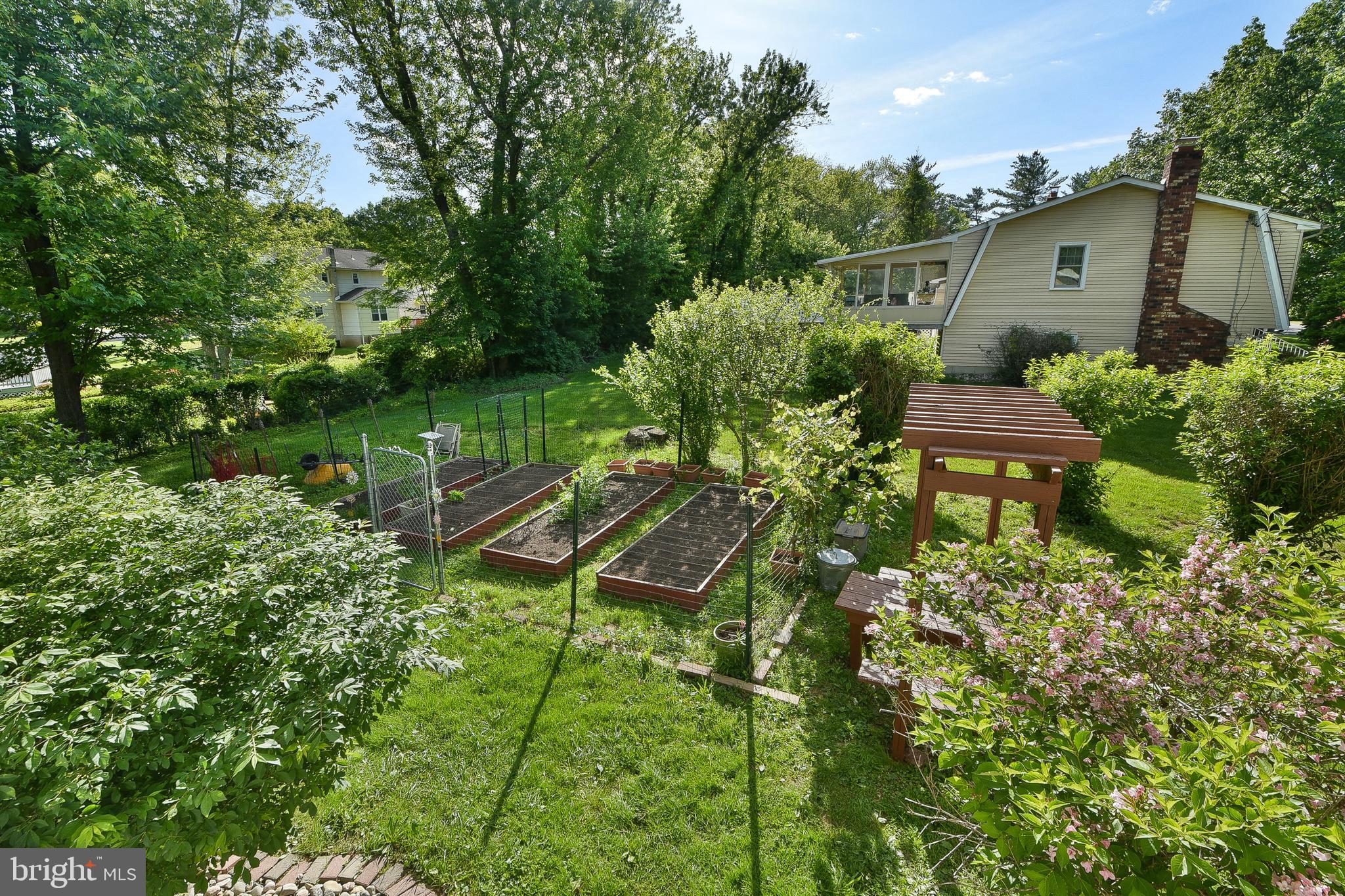 192 Bull Run Road Ewing, NJ 08638 - Photo 41 of 46 a view of a garden with plants and a bench