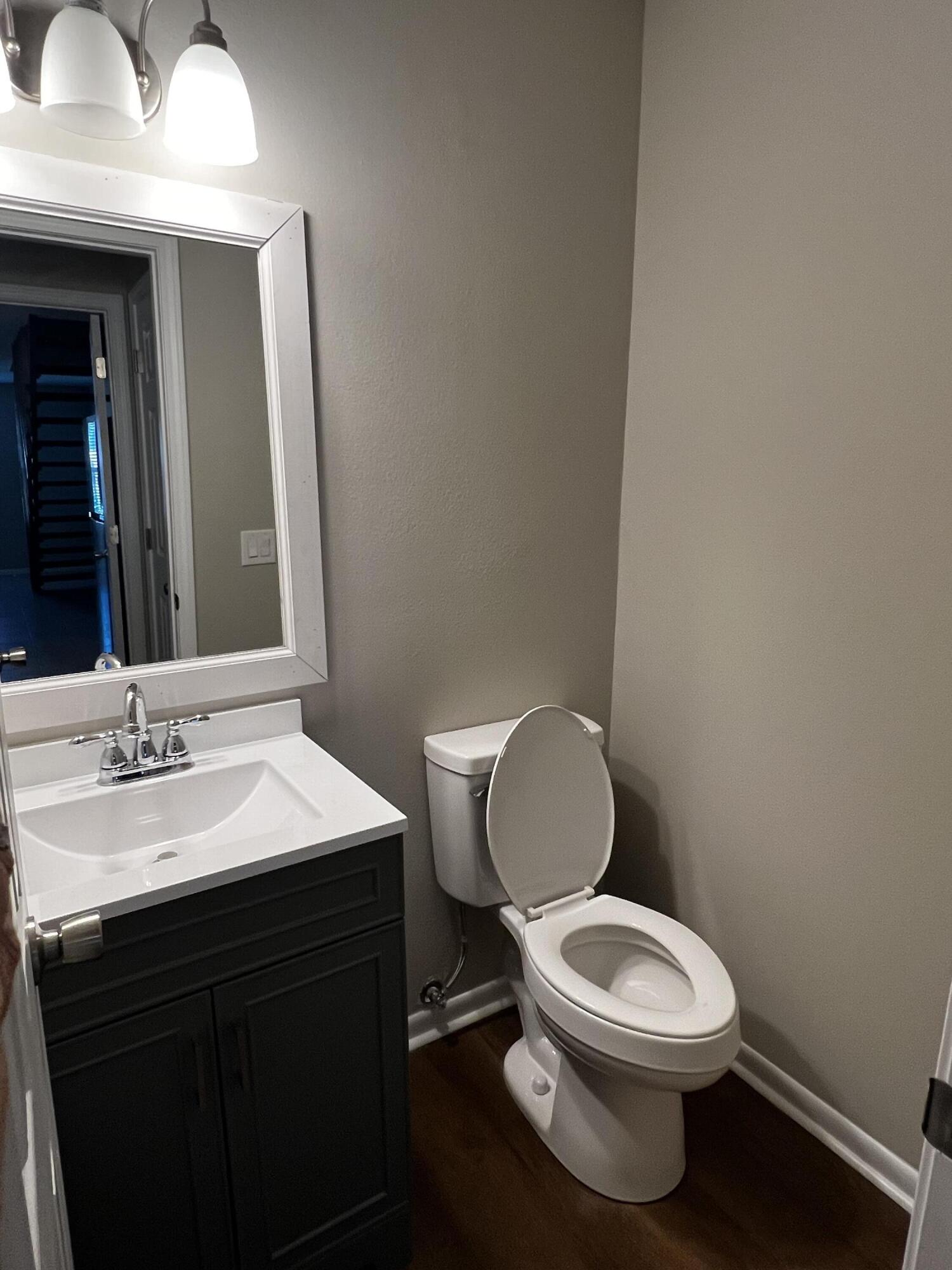 124 Hampton Drive Crestview, FL 32539 - Photo 6 of 12 a bathroom with a toilet a sink and mirror
