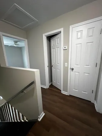 an empty room with wooden floor and closet