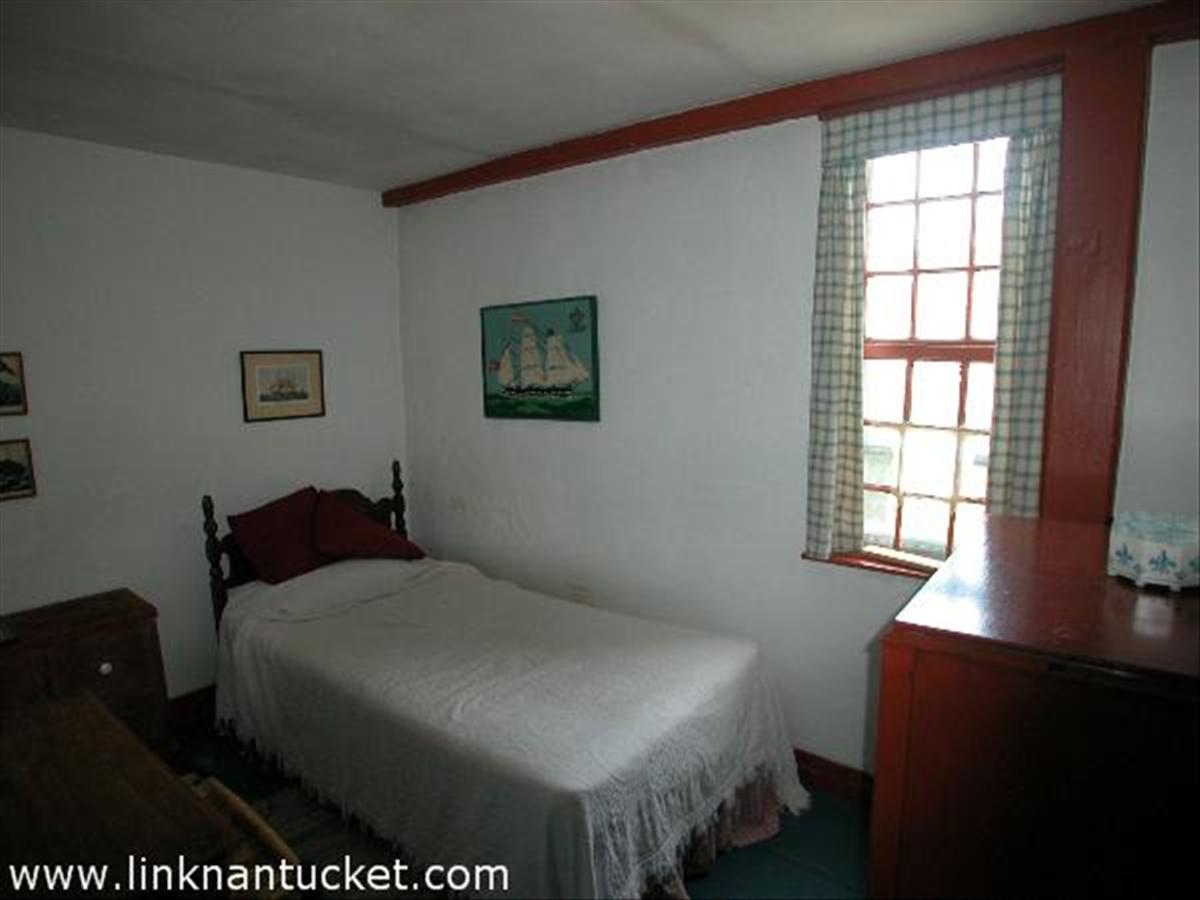 2 Cliff Road Nantucket, MA 02554 - Photo 13 of 19 a bedroom with a bed and a window