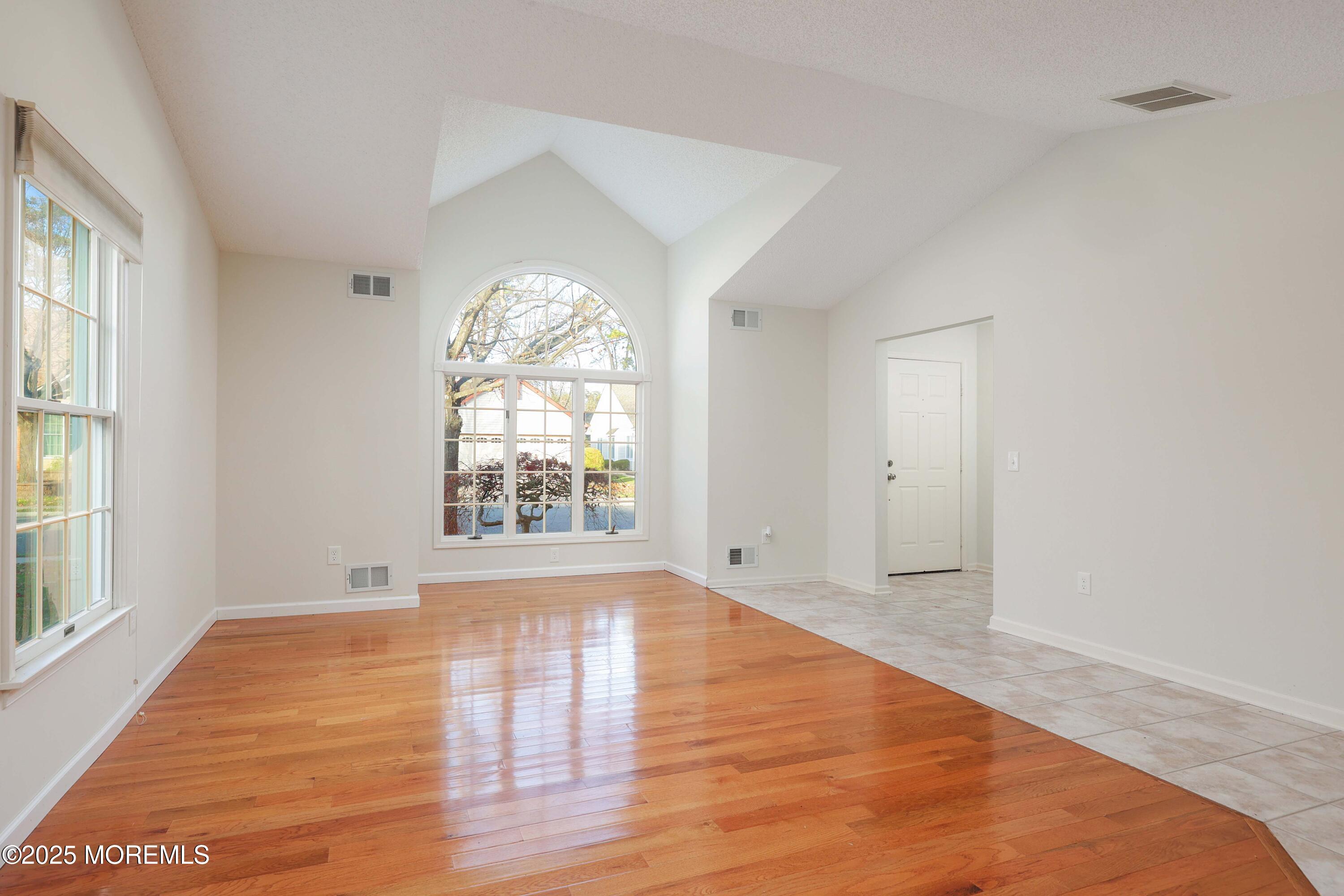 1665 Goldspire Road Toms River, NJ 08755 - Photo 12 of 37 an empty room with wooden floor and windows