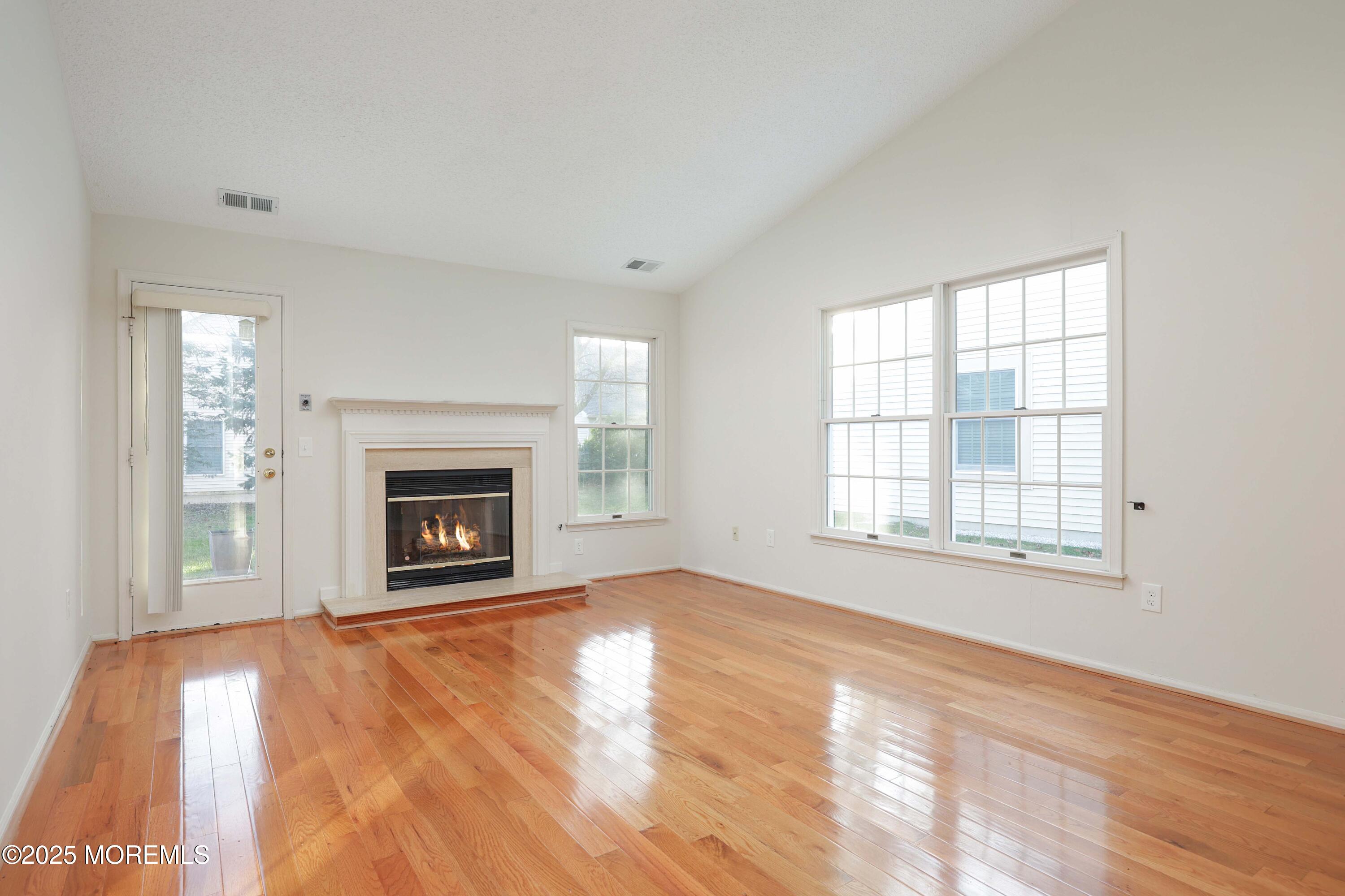 1665 Goldspire Road Toms River, NJ 08755 - Photo 18 of 37 a view of empty room with fireplace and wooden floor