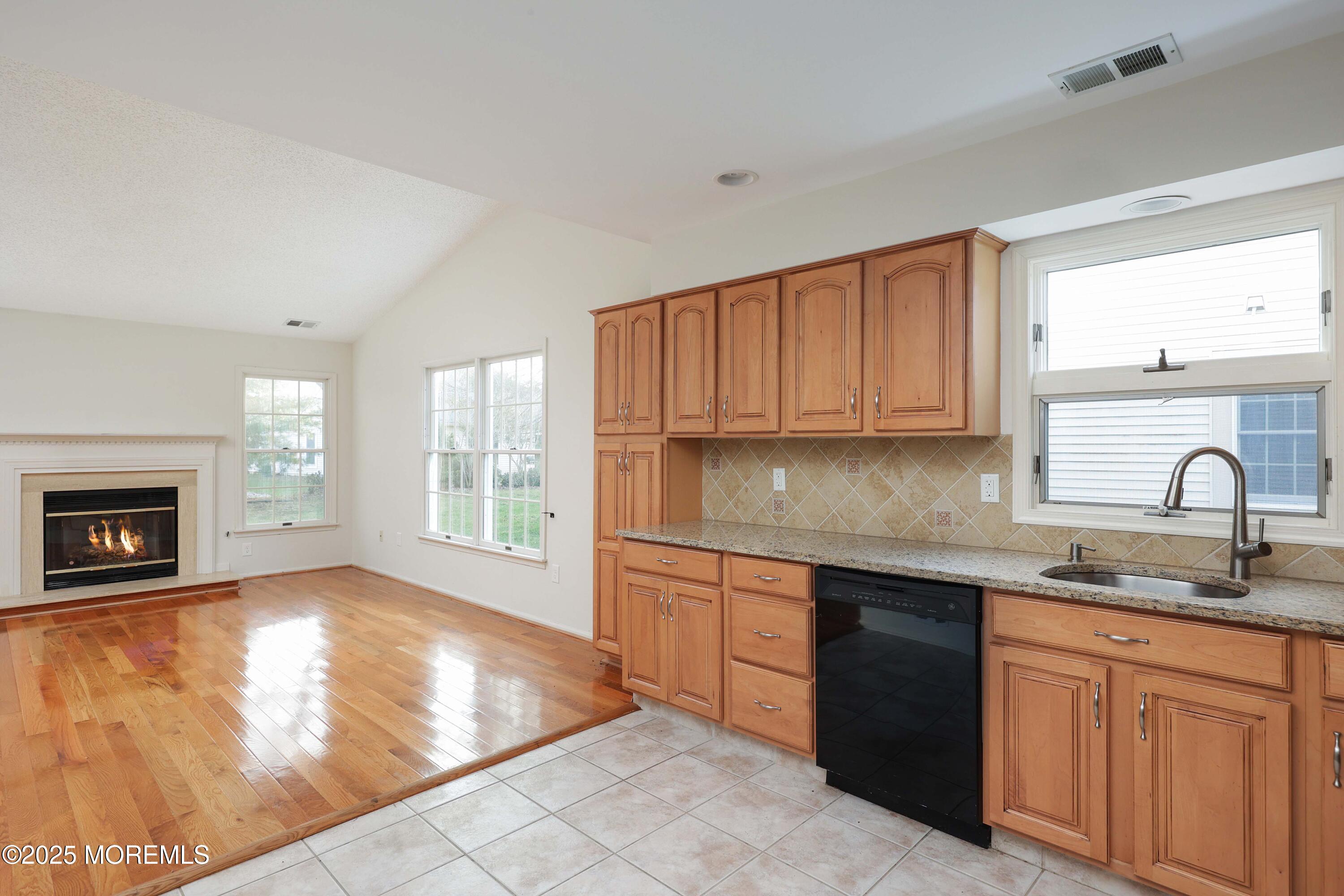 1665 Goldspire Road Toms River, NJ 08755 - Photo 23 of 37 a kitchen with granite countertop a stove sink and cabinets