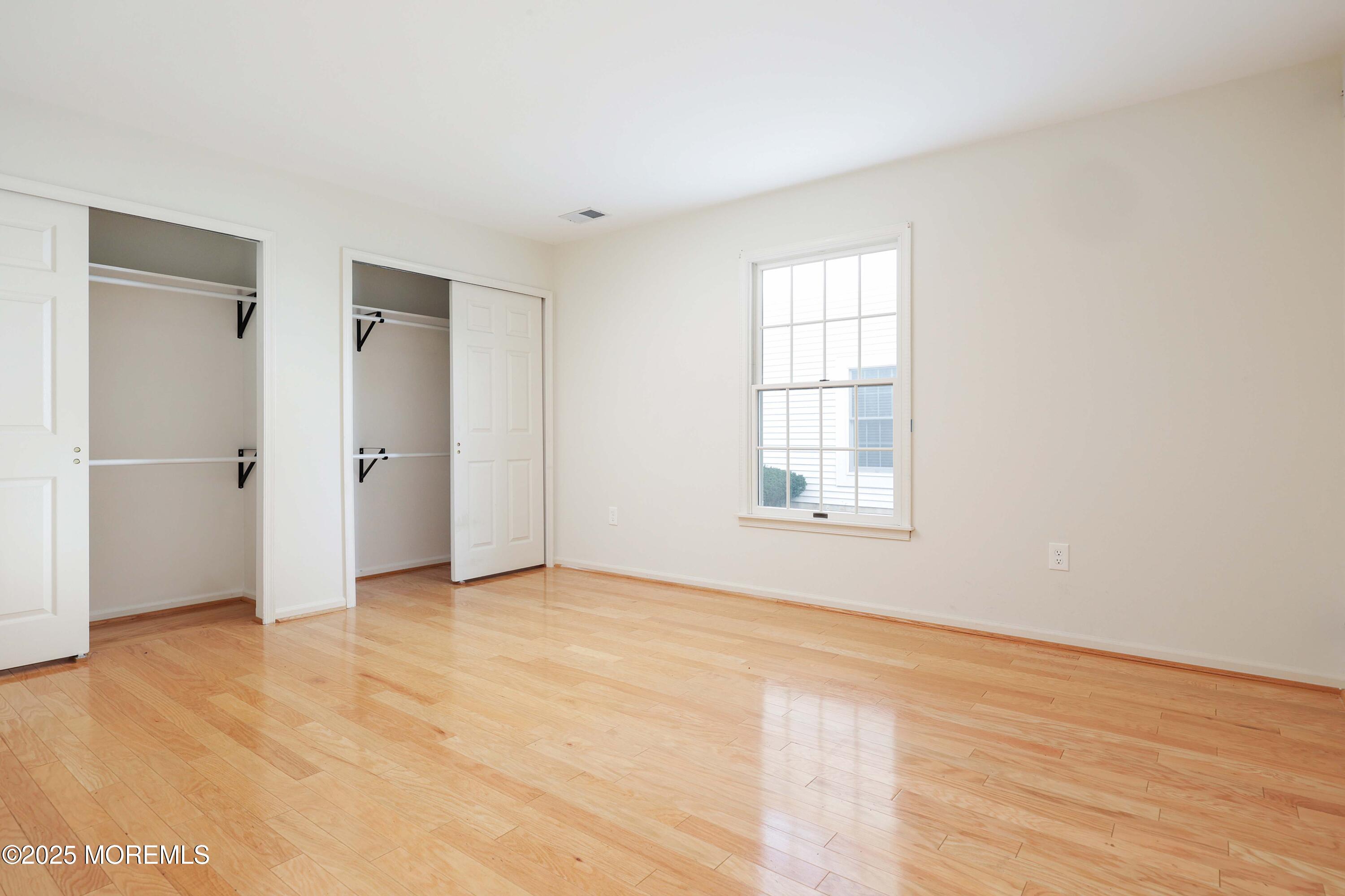 1665 Goldspire Road Toms River, NJ 08755 - Photo 33 of 37 a view of an empty room with wooden floor and a window