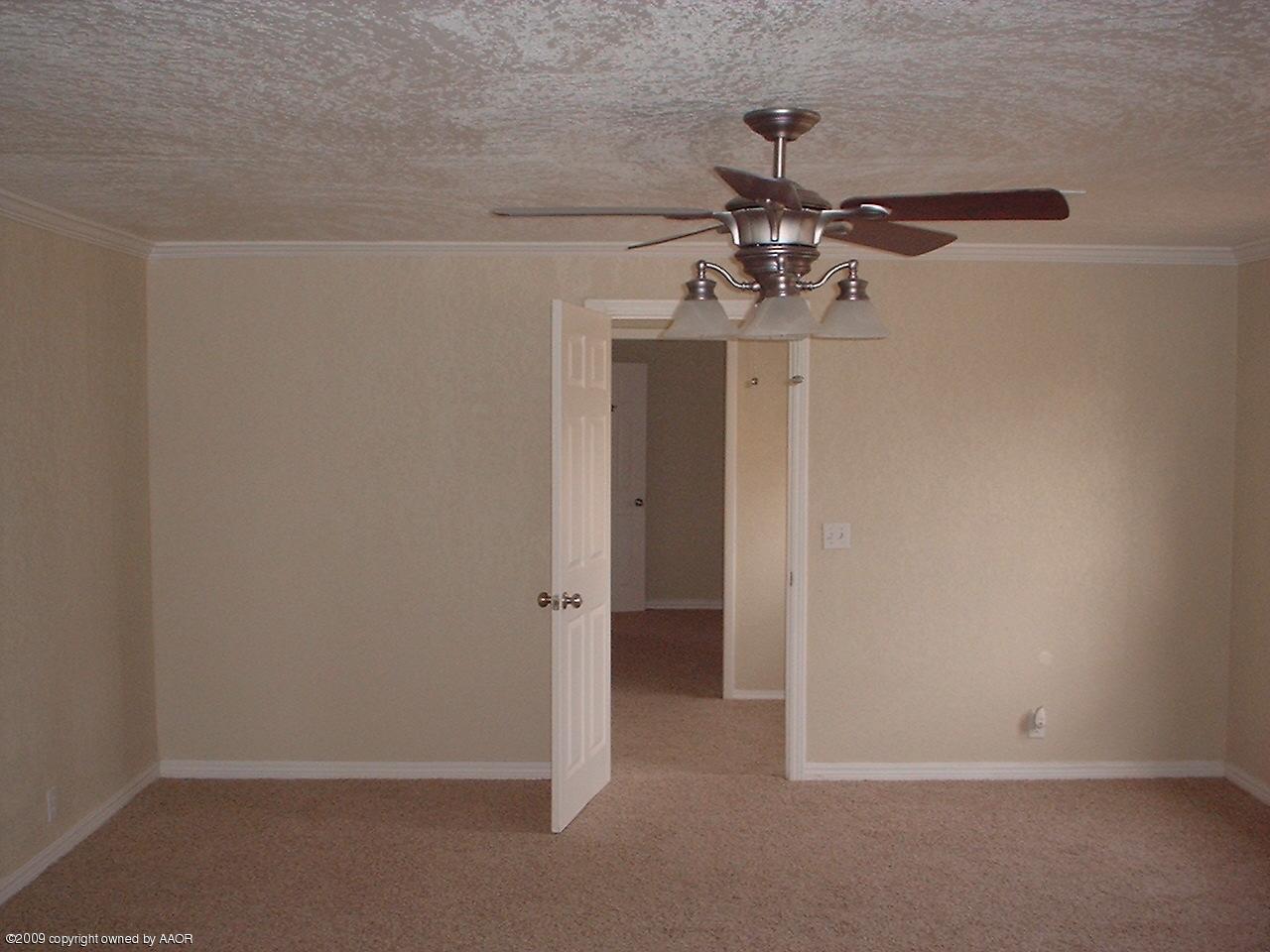 4200 South Tyler Street Amarillo, TX 79110 - Photo 2 of 8 a view of a chandelier fan and refrigerator in a room