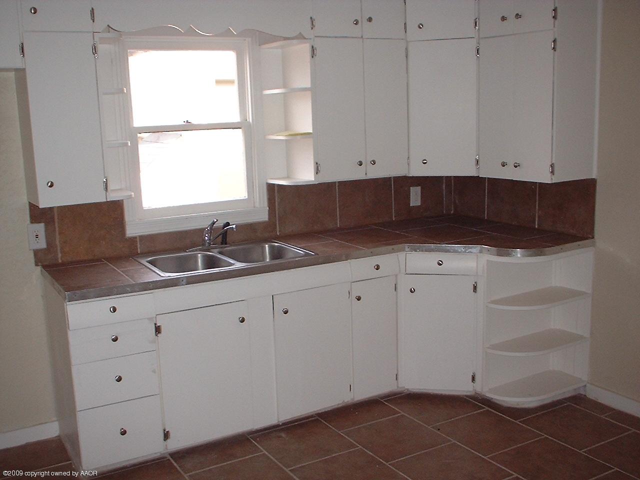 4200 South Tyler Street Amarillo, TX 79110 - Photo 3 of 8 a kitchen with granite countertop white cabinets and sink