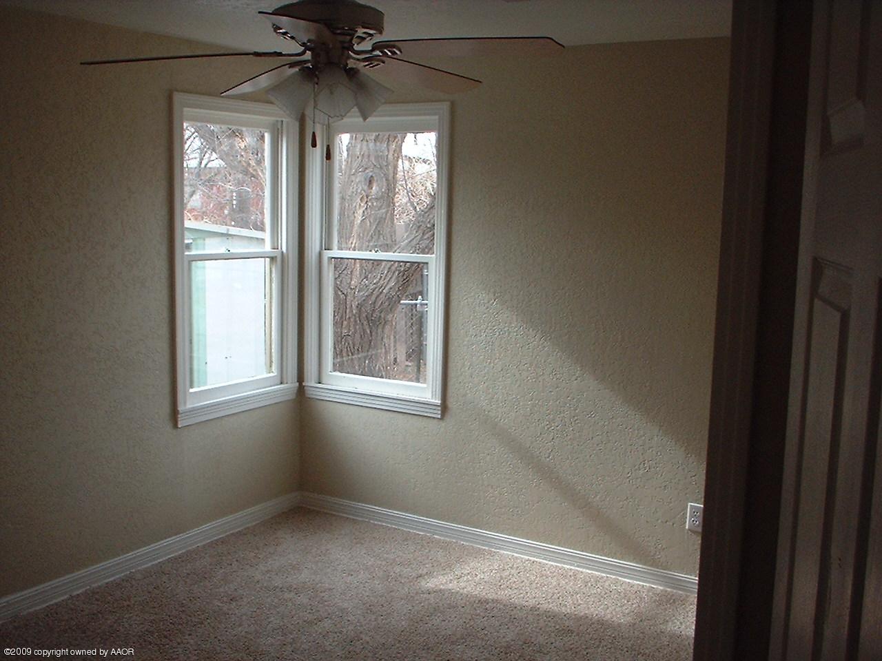 4200 South Tyler Street Amarillo, TX 79110 - Photo 8 of 8 a view of an empty room with a window