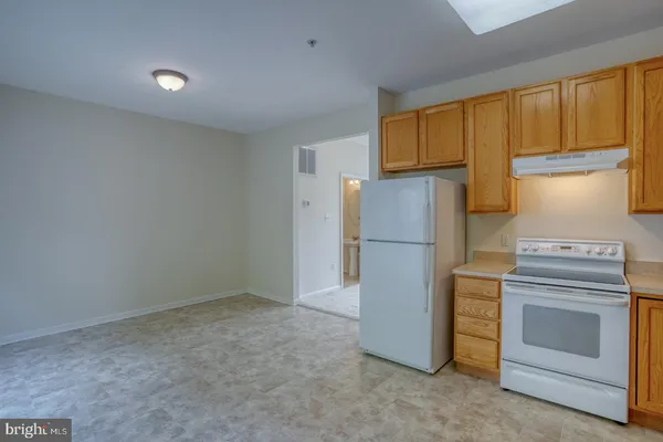 a kitchen with a sink a stove and cabinets