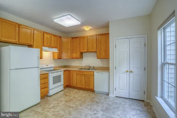 a kitchen with a refrigerator and a sink