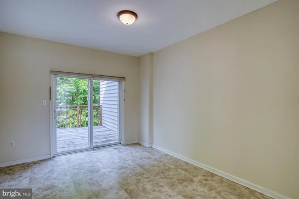 a view of a dining room with furniture a chandelier and wooden floor