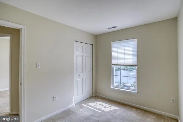 a bathroom with a granite countertop toilet sink and mirror