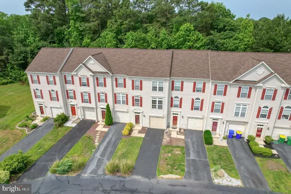 an aerial view of a house with outdoor space and garden