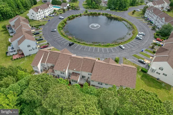 an aerial view of multiple houses with yard