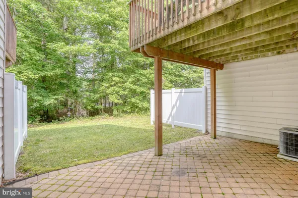 a view of a backyard with a shade house and large tree