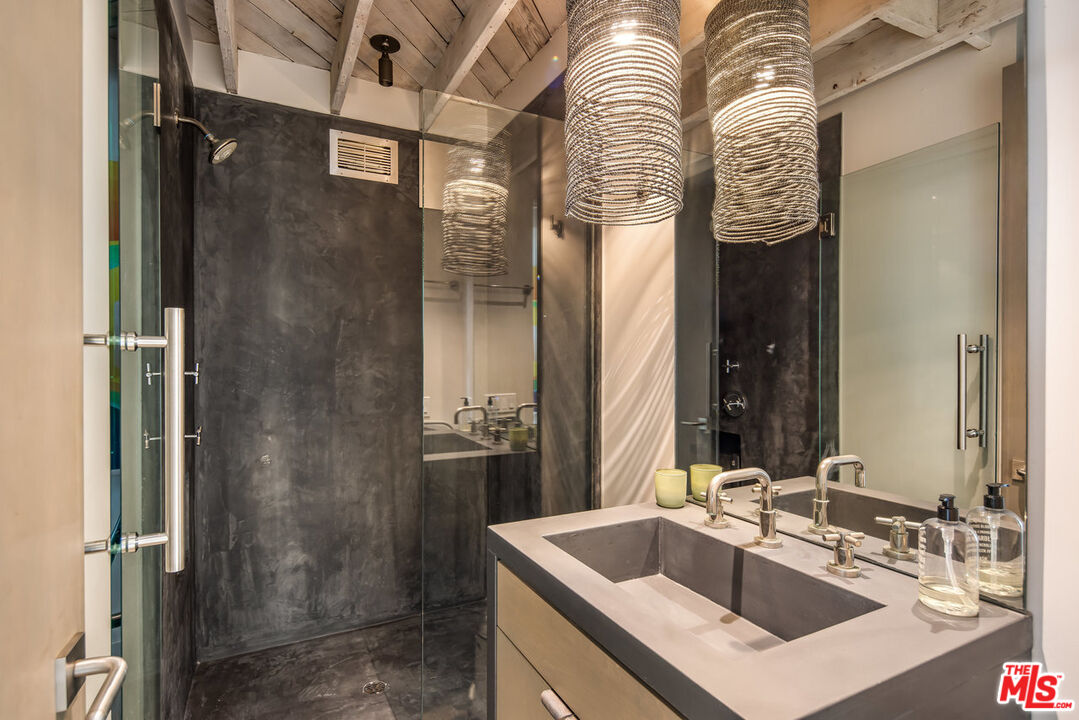 24956 Malibu Road Malibu, CA 90265 - Photo 21 of 33 a bathroom with a sink and a mirror