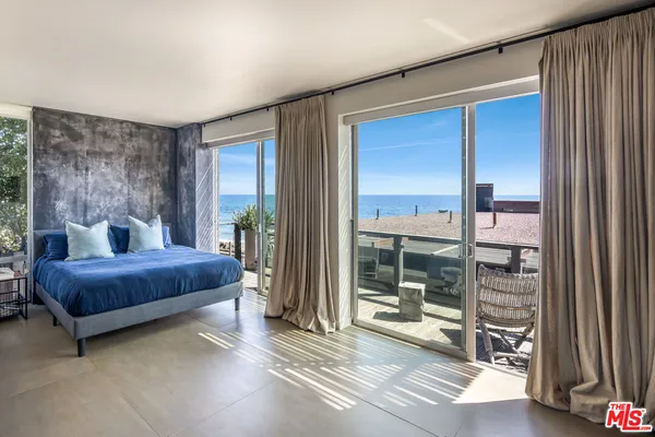 a living room with furniture and a floor to ceiling window