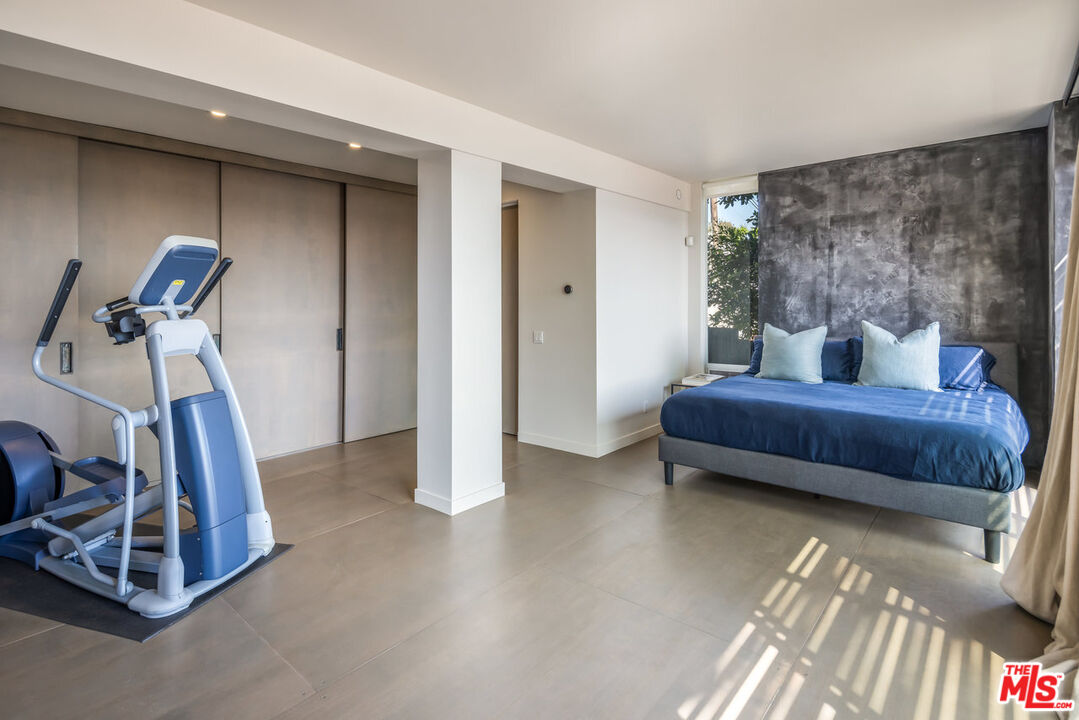 24956 Malibu Road Malibu, CA 90265 - Photo 28 of 33 a bedroom with furniture and a gym machine