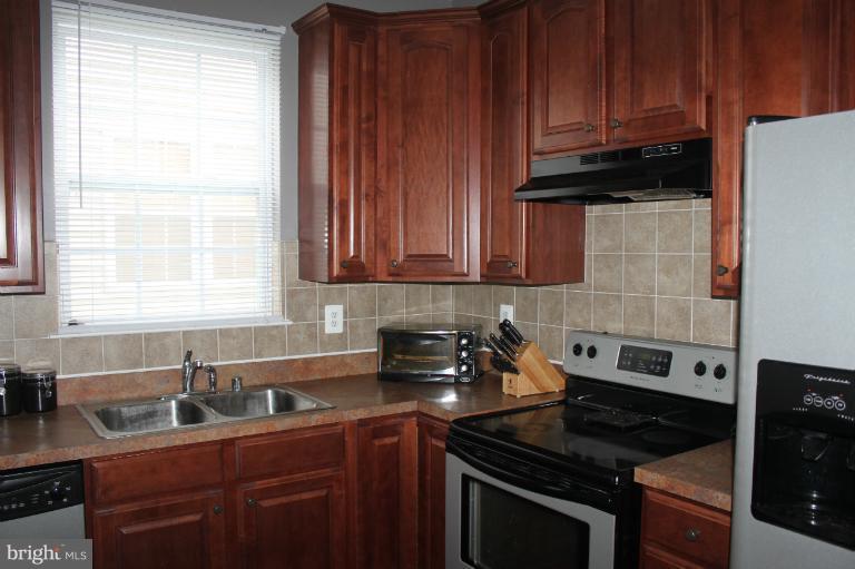 707 MacDill Road Baltimore, MD 21220 - Photo 5 of 20 a kitchen with stainless steel appliances granite countertop a sink stove and cabinets