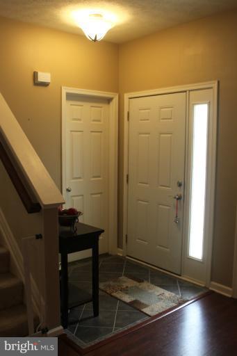 707 MacDill Road Baltimore, MD 21220 - Photo 6 of 20 an empty room with wooden floor and windows