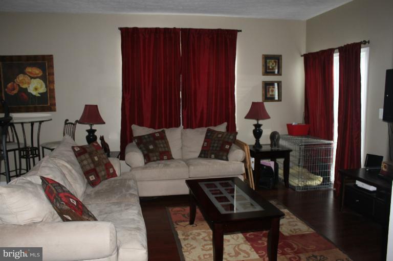 707 MacDill Road Baltimore, MD 21220 - Photo 7 of 20 a living room with furniture a rug and a window