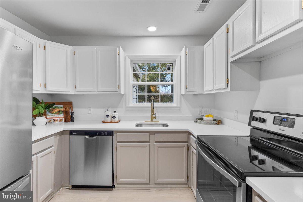 2227 Rock Creek Road Fredericksburg, VA 22407 - Photo 11 of 31 a kitchen with a sink stove top oven and cabinets