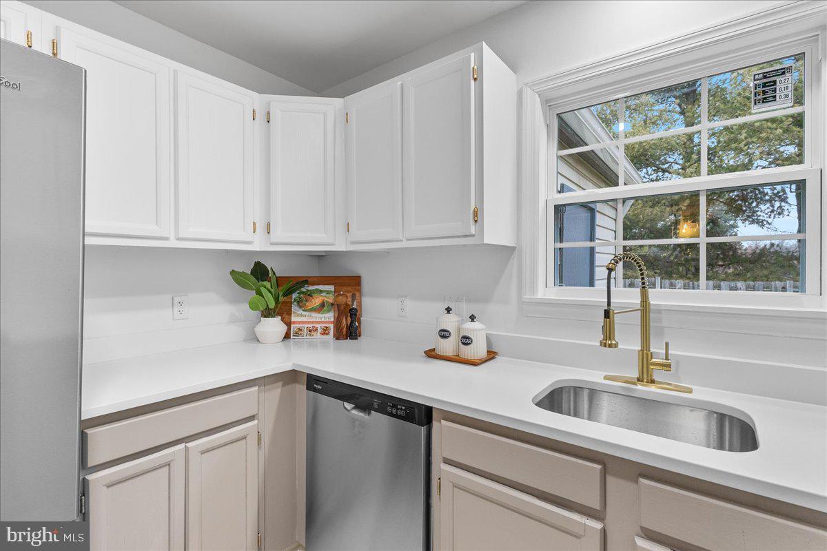 2227 Rock Creek Road Fredericksburg, VA 22407 - Photo 12 of 31 a kitchen with a sink cabinets and a window
