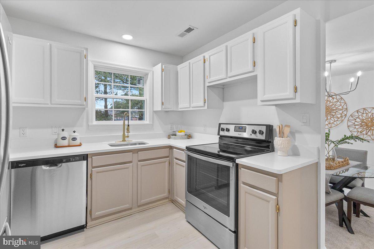 2227 Rock Creek Road Fredericksburg, VA 22407 - Photo 13 of 31 a kitchen with cabinets appliances a sink and a window