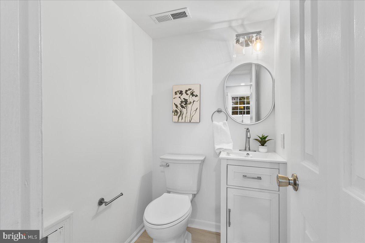 2227 Rock Creek Road Fredericksburg, VA 22407 - Photo 14 of 31 a white toilet sitting next to a bathroom sink