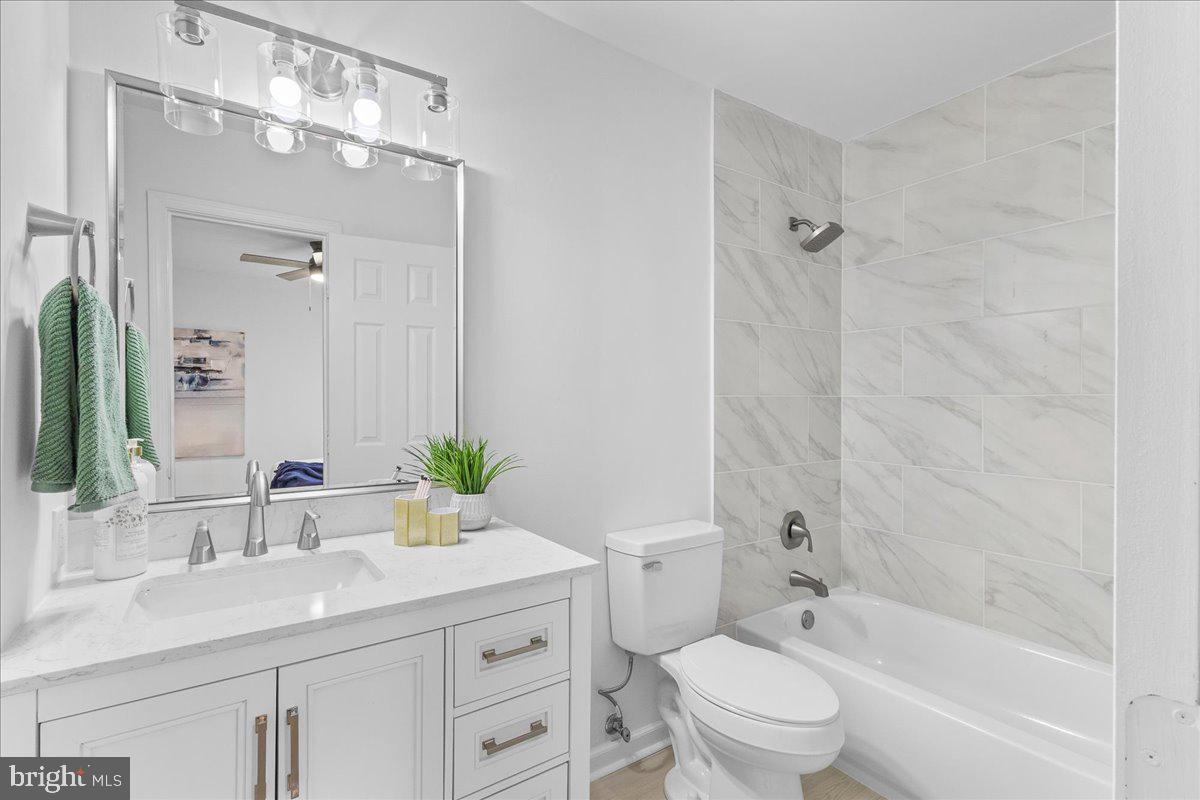 2227 Rock Creek Road Fredericksburg, VA 22407 - Photo 18 of 31 a bathroom with a sink a toilet and shower