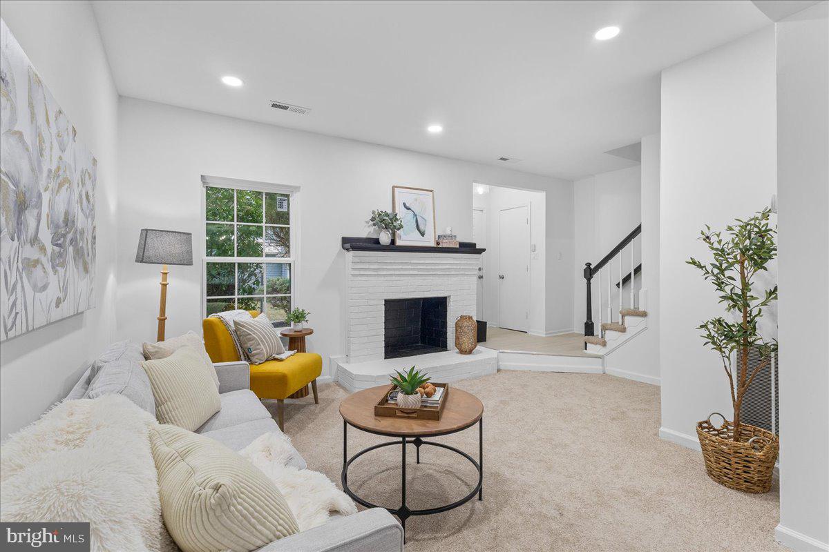 2227 Rock Creek Road Fredericksburg, VA 22407 - Photo 2 of 31 a living room with furniture potted plant and a fireplace