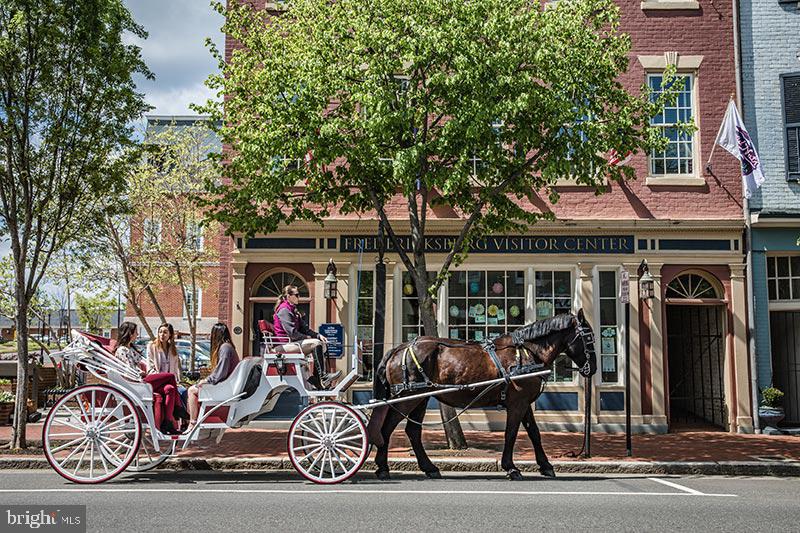 2227 Rock Creek Road Fredericksburg, VA 22407 - Photo 30 of 31 a couple of table and chairs in front of a building