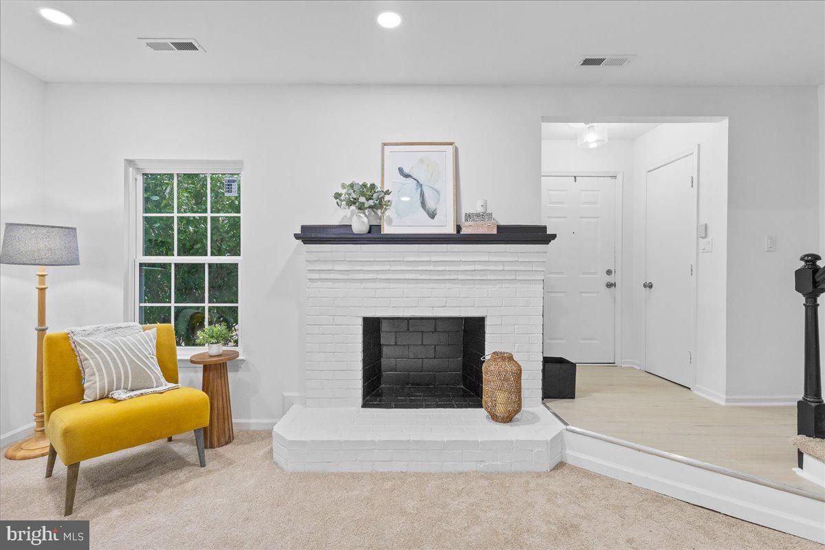 2227 Rock Creek Road Fredericksburg, VA 22407 - Photo 4 of 31 a living room with furniture and a fireplace