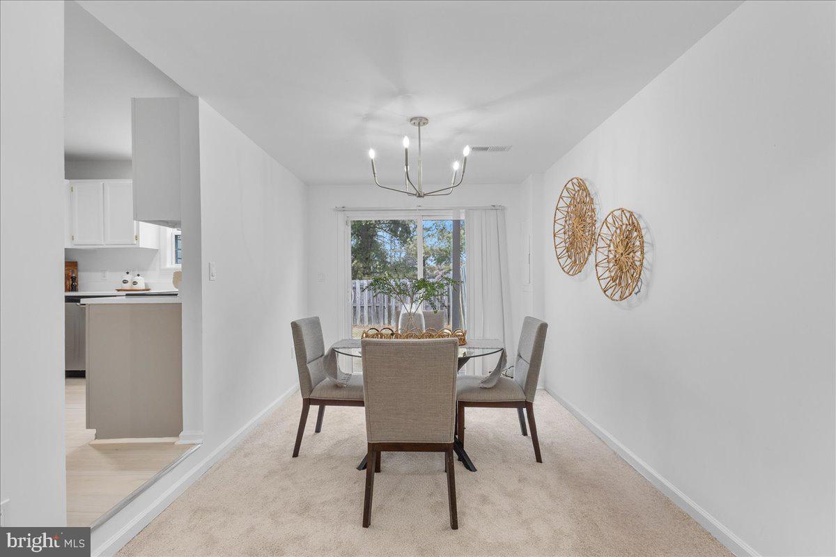2227 Rock Creek Road Fredericksburg, VA 22407 - Photo 8 of 31 a view of a dining room with furniture window and wooden floor