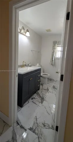 a bathroom with a sink vanity and mirror
