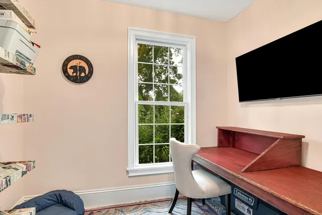 a view of a livingroom with furniture and a flat screen tv