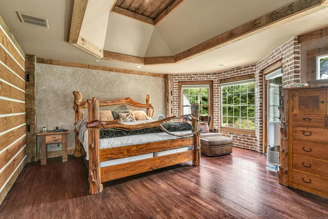 a bedroom with furniture and wooden floor