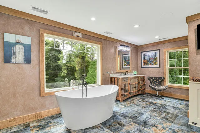 a living room with furniture and large windows