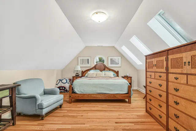 a spacious bedroom with a bed a couch and dresser