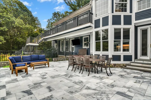 a view of a building with chairs and table in the patio