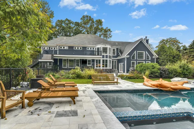 a view of a house with backyard sitting area and garden