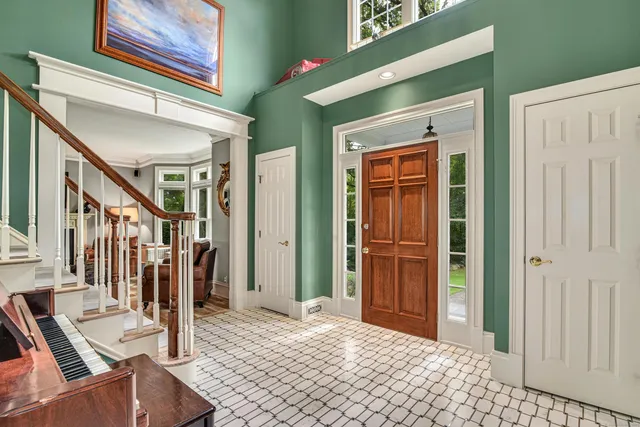 a bedroom with a bed and a mirror on the dresser