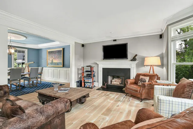 a living room with furniture fireplace and flat screen tv