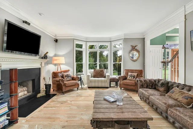 a living room with furniture a flat screen tv and a fireplace