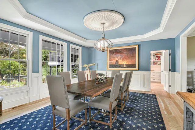 a view of a dining room with furniture wooden floor and chandelier
