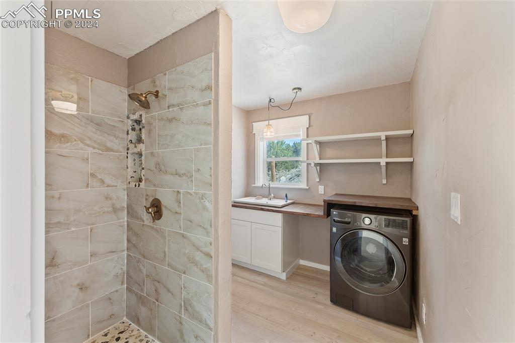 659 Turrell Trail Penrose, CO 81240 - Photo 11 of 19 a view of a bathroom with a sink and a washer dryer